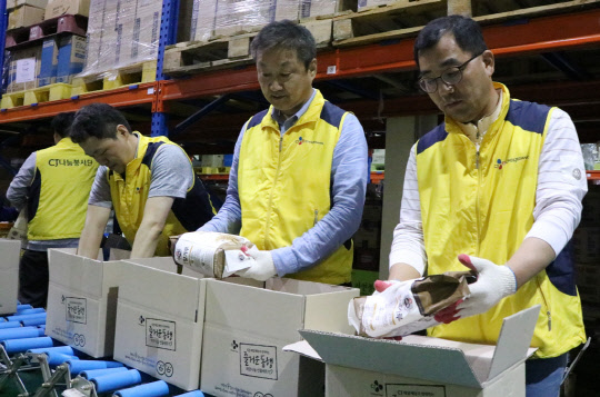 CJ제일제당은 지난 23일 서울 창4동 서울광역푸드뱅크에서 '푸드뱅크 희망나눔 선물세트' 조립 봉사활동을 진행했다. 이날 봉사활동에서 신현재 CJ제일제당 대표(오른쪽 두번째부터), 강신호 CJ제일제당 식품사업부문 대표가 희망나눔 선물세트를 조립하는 모습. <CJ제일제당 제공>